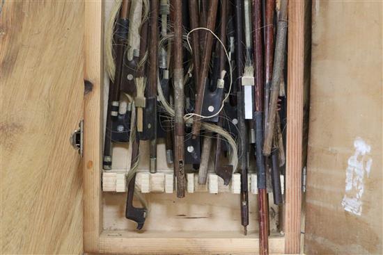 Two violins in a mahogany box and a collection of violin bows